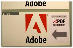 Adobe's door sign and paper showing the PDF Conference is here!
