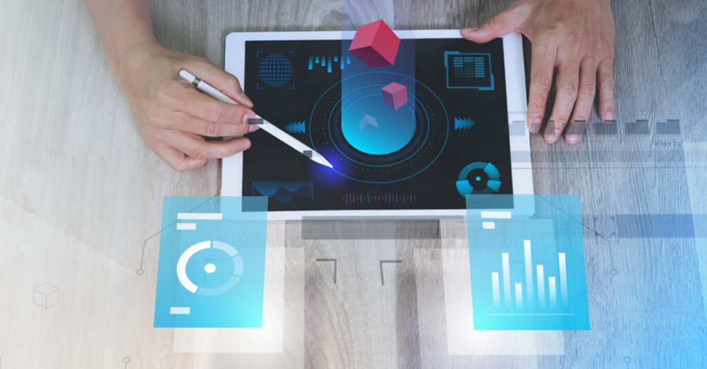 tablet with mouse on top of screen and person holding an electronic pencil to the screen